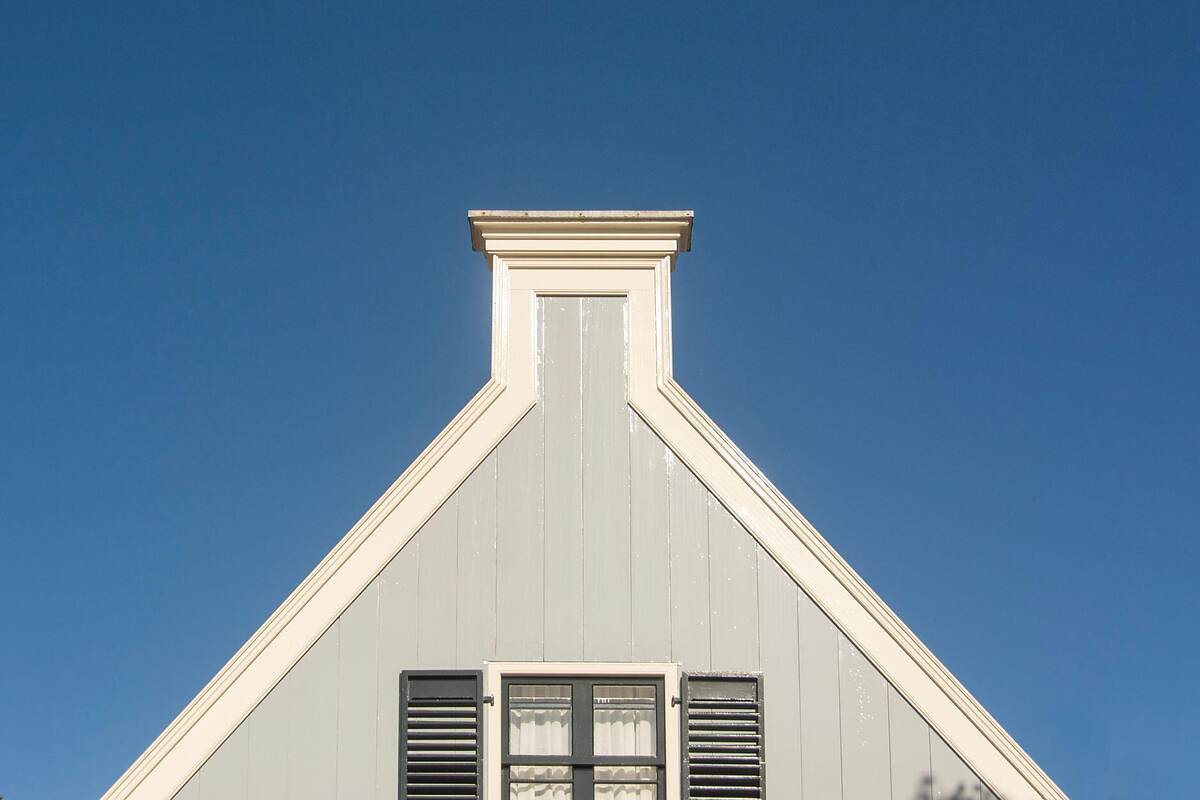 A louvered gable vent high on the end wall of a house