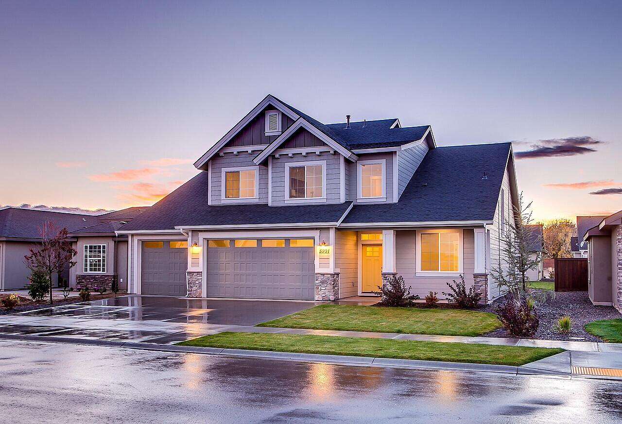 Two-story houses along a suburban street with young trees